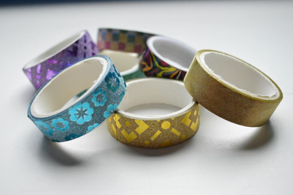 Close-up of assorted colorful decorative tape rolls arranged in a circle.