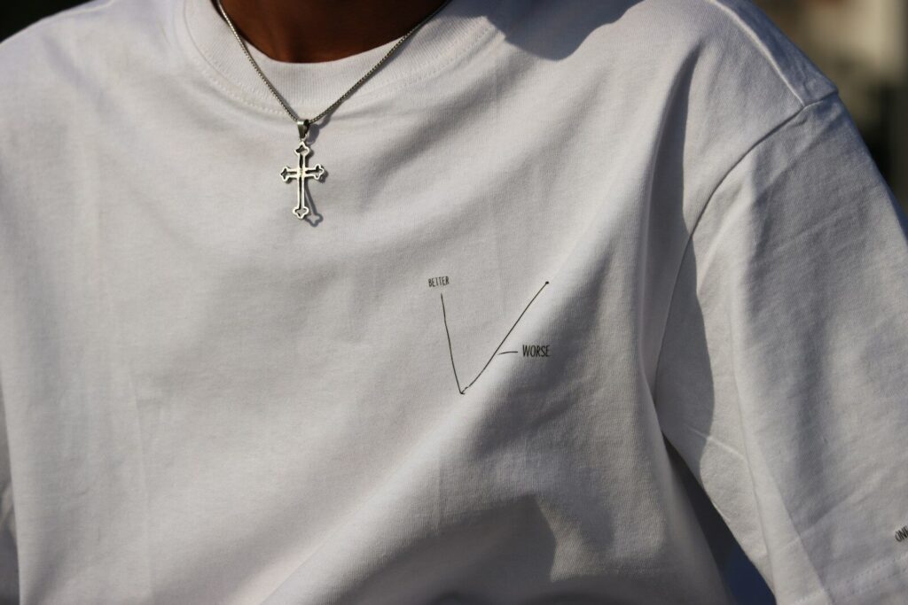 a person wearing a white shirt with a cross on it