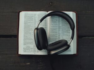 black wireless headphones on white book page