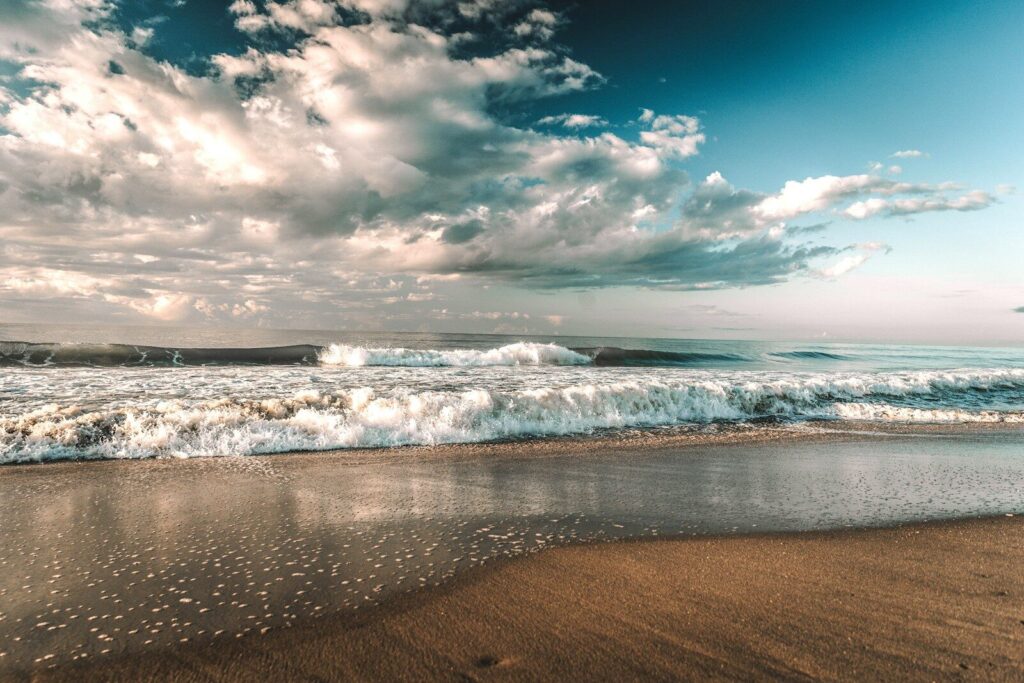 sea waves crashing on shore under blue and white cloudy sky during daytime Myrtle Beach